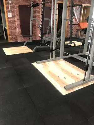 a gym with wooden flooring and a bunch of equipment at Alex Residence in Larnaka