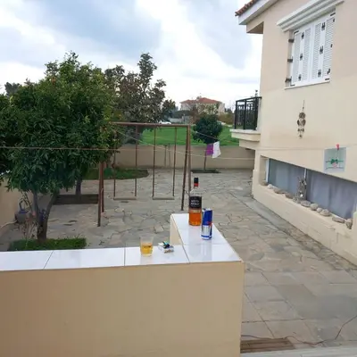 a table with drinks on it next to a courtyard at Vasilis House family room in Larnaka
