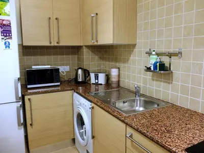 a kitchen with a sink and a washing machine at Tersefanou Traditional Village Larnaca in Larnaka
