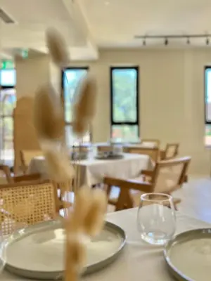 a dining room with white plates on a table at Thymises Boutique Hotel in Kakopetria