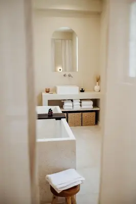 a bathroom with a tub and a sink and a mirror at Thymises Boutique Hotel in Kakopetria