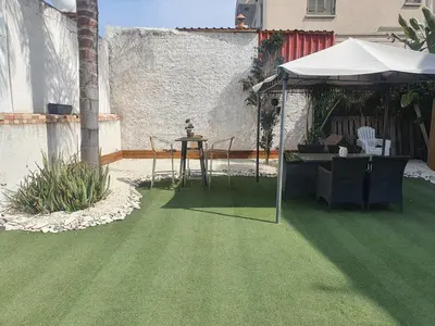 a patio with a table and an umbrella at Trudy's home in Nicosia