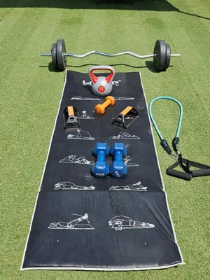 a table with weights and equipment on the grass at Trudy's home in Nicosia