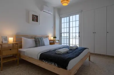 a bedroom with a bed with two towels on it at Blossom 1-Bedroom Apartment in Larnaca in Larnaka