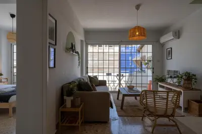 a living room with a couch and a table at Blossom 1-Bedroom Apartment in Larnaca in Larnaka