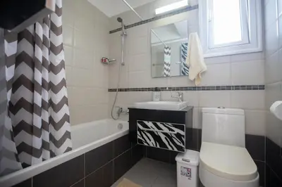 a bathroom with a toilet and a sink and a tub at Pelagos Villa 8 in Protaras