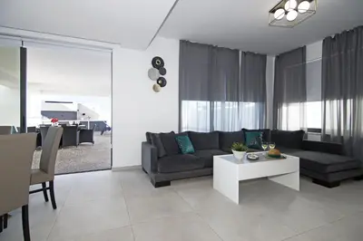 a living room with a couch and a table at Villa Amazonia - Large Private Pool in Protaras