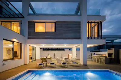 an exterior view of a house with a swimming pool at Villa Amazonia - Large Private Pool in Protaras