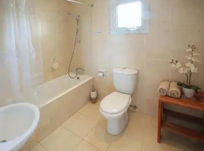 a bathroom with a toilet and a tub and a sink at Villa Kos 19 in Protaras