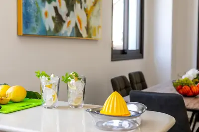 a dining room table with a bowl of fruit on it at Protaras Villa Angela Nefeli in Paralimni