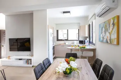 a kitchen and dining room with a table and chairs at Protaras Villa Angela Nefeli in Paralimni