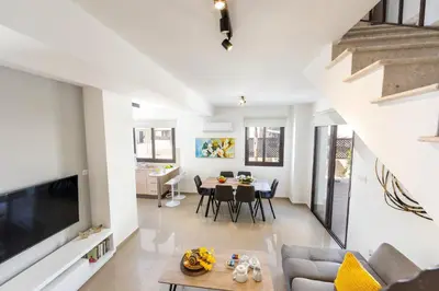 a living room with a couch and a table at Protaras Villa Angela Nefeli in Paralimni
