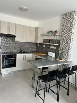 a kitchen with a table and chairs in it at Stay With Oleg C111 in Paralimni