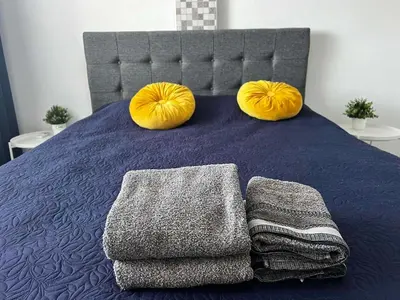 a bed with two large yellow pillows on it at Stay With Oleg C111 in Paralimni