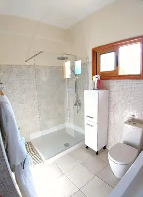 a bathroom with a shower and a toilet and a tub at Villa Christina in Protaras