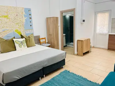 a bedroom with a bed and a map on the wall at Larnaca - Studio - Sleeps 4 - Garden - Parking in Larnaka