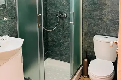 a bathroom with a shower with a toilet and a sink at Larnaca - Studio - Sleeps 4 - Garden - Parking in Larnaka