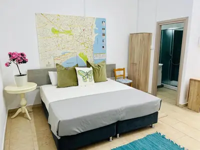 a bedroom with a bed with a map on the wall at Larnaca - Studio - Sleeps 4 - Garden - Parking in Larnaka
