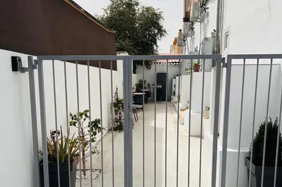 a white fence with some plants and a table at Larnaca - Studio - Sleeps 4 - Garden - Parking in Larnaka