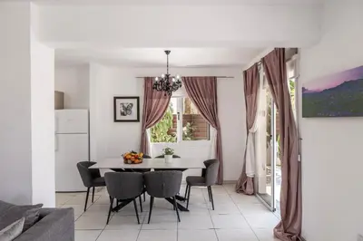 a dining room with a table and chairs at Nissini villa in Ayia Napa