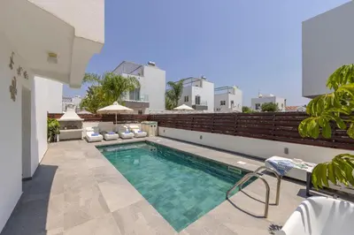 a swimming pool on the roof of a house at Nissini villa in Ayia Napa