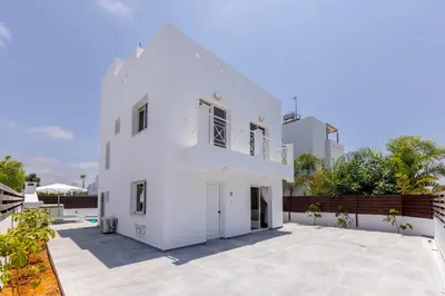 a white house with a courtyard in front of it at Nissini villa in Ayia Napa
