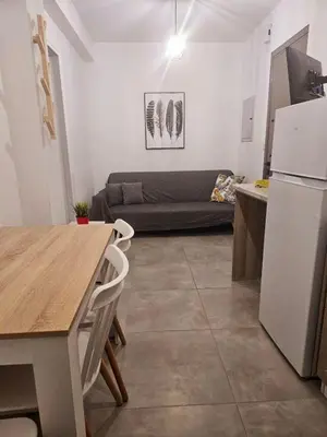 a kitchen and living room with a couch and a refrigerator at SC_apartments in Kato Pyrgos