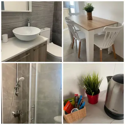 a bathroom with a sink and a table with a sink at SC_apartments in Kato Pyrgos