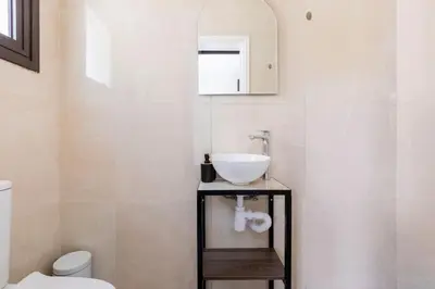 a bathroom with a sink and a toilet at Epicurian Residence in Nicosia