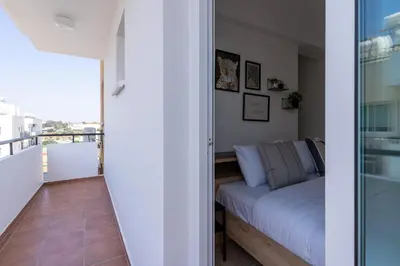 a living room with a couch and a balcony at Chloris 3- Bedroom Apartment W/Pool in Larnaca in Larnaka
