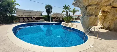 a large pool with blue water in a resort at Pyla Palms Resort B1 - 1 in Larnaka