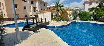 a swimming pool with a slide next to a building at Pyla Palms Resort B1 - 1 in Larnaka