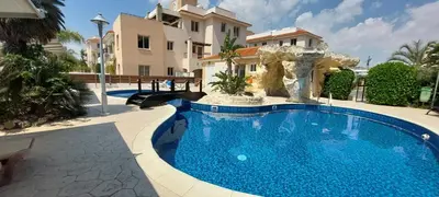 a swimming pool in front of a house at Pyla Palms Resort B1 - 1 in Larnaka