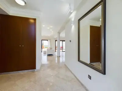 a large mirror on a wall in a hallway at Fabulous beach front house with pool in Larnaka