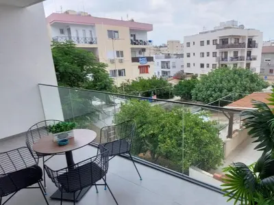 a balcony with a table and chairs and a view at New Smart Living-1 Bedroom Aglantzia, Nicosia in Aglantzia