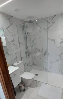 a bathroom with a toilet and a glass shower at New Smart Living-1 Bedroom Aglantzia, Nicosia in Aglantzia