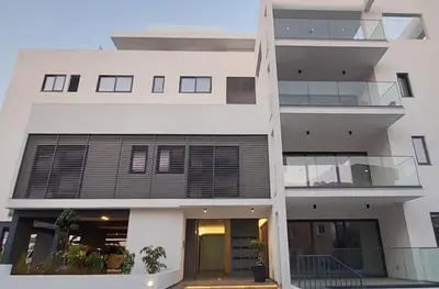 a white building with balconies on the side of it at New Smart Living-1 Bedroom Aglantzia, Nicosia in Aglantzia