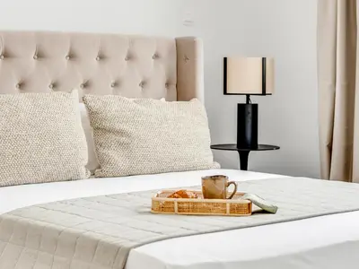 a tray of food and a cup of coffee on a bed at Sanders Premier Downtown in Limassol