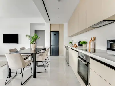 a kitchen and dining room with a table and chairs at Sanders Premier Downtown in Limassol