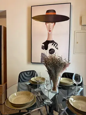 a dining room with a glass table and a picture at Cozy house city center in Limassol in Limassol
