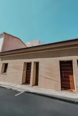 a building with four doors on the side of it at Cozy house city center in Limassol in Limassol