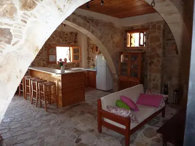 a kitchen with an archway and a couch in a room at The House of Pericles in Silikou