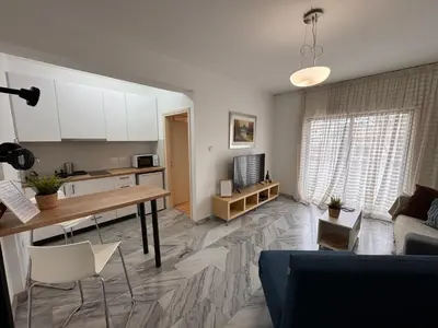 a kitchen and living room with a table and a couch at Nicosia Downtown Cozy in Nicosia
