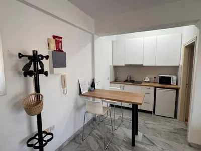 a small kitchen with a table and a counter at Nicosia Downtown Cozy in Nicosia