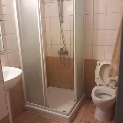 a bathroom with a shower with a toilet and a sink at A CHEERFUL APARTMENT in a popular area in Pallouriotissa