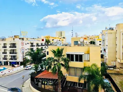 a view of a city with palm trees and buildings at Mackenzie apartment 301 in Larnaka