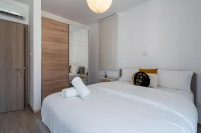 a bedroom with a large white bed with white pillows at Flair - 1-Bedroom Apartment & Balcony in Larnaca in Larnaka