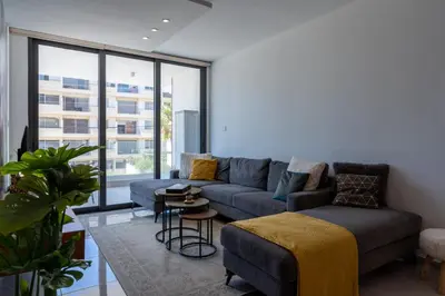 a living room with a couch and a table at Flair - 1-Bedroom Apartment & Balcony in Larnaca in Larnaka