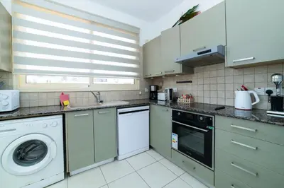 a kitchen with a washing machine and a washer at Villa Anna Maria, Kapparis in Paralimni