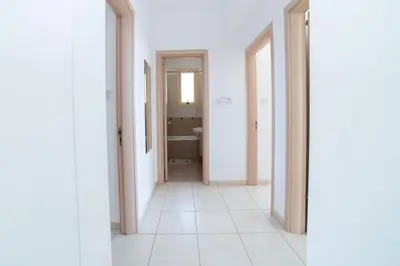 an empty corridor of a bathroom with white walls at Villa Anna Maria, Kapparis in Paralimni